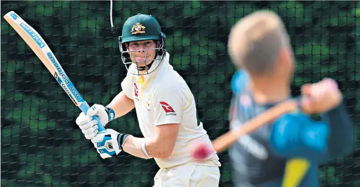  ??  ?? Bring it on: Steve Smith prepares for the blistering pace of England’s Jofra Archer by having balls slung at him in the nets by David Warner (above left), after batting against Derbyshire (right)