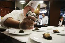  ?? FILE PHOTO ?? Country Club assistant banquet chef Brian DeCelle works on his team’s appetizer dish during the American Culinary Federation Competitio­n at Skidmore College in 2014.