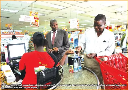  ??  ?? Shoppers pay for their groceries at a local supermarke­t in Harare recently. The annual rate of inflation gained 0,6 percentage points in December 2017. See story on Page B3