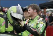  ?? THE ASSOCIATED PRESS FILE PHOTO ?? Dale Earnhardt Jr., reaches for his helmet before qualifying Friday in Brooklyn, Mich. With Earnhardt retiring after this season, his seat in the No. 88 Chevrolet is the biggest prize of free agency for drivers.