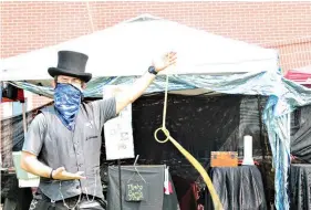  ??  ?? Cedric Morley, of Morley Family Magic, amazes and astounds children during the SouthArk Foundation’s Outdoor Expo on Saturday. (Caitlan Butler/News-Times)