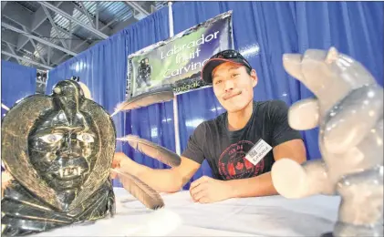  ?? TELEGRAM FILE ?? Inuit carver Elias Semigak shows off some of his carvings at a craft fair at the Jack Byrne Arena in 2012. Some suggest that in a future Canada there will be a shift in demand towards labour-intensive work, such as artisanal products valued because...