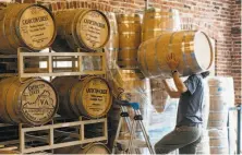  ?? Justin T. Gellerson / New York Times ?? A distiller moves barrels around the warehouse at Catoctin Creek distillery in Purcellvil­le, Va.