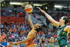  ?? ROSS D. FRANKLIN/AP PHOTO ?? Phoenix Mercury guard Yvonne Turner, left, gets off a shot in front of Seattle Storm forward Breanna Stewart (30) as Storm guard Jewell Loyd, rear, watches during the second half of Game 3 Friday. The Mercury defeated the Storm 86-66 in the WNBA semifinal series.