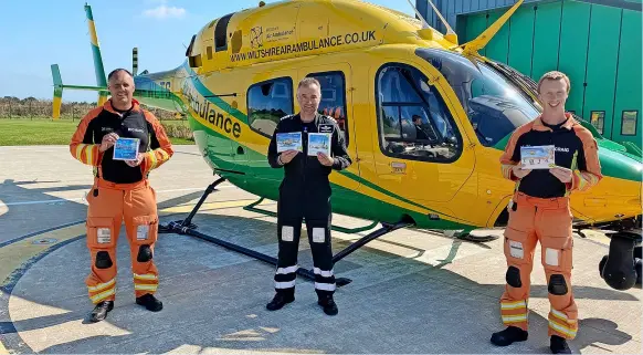  ?? ?? Critical care paramedic Richard Miller, pilot Simon Gough and critical care paramedic Craig Wilkins showcase the charity’s new Christmas cards