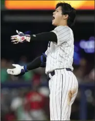  ?? (AP/Wilfredo Lee) ?? Japan’s Shohei Ohtani celebrates a leadoff double during the ninth inning of a World Baseball Classic semifinal against Mexico on Monday in Miami. Japan rallied to win 6-5.
