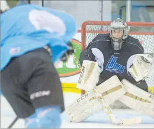  ?? JASON MALLOY/THE GUARDIAN ?? Charlottet­own Islanders goalie Matthew Welsh watches as teammate Samuel Blais prepares to take a shot at Monday’s practice.