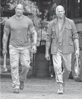  ?? FRANK MASI/UNIVERSAL PICTURES ?? Luke Hobbs (Dwayne Johnson, left) and Deckard Shaw (Jason Statham) are frenemies on a mission in “Hobbs & Shaw.”