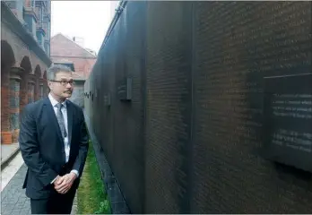  ?? PHOTOS BY CAO LEI / FOR CHINA DAILY ?? Dean Bloch, the son of Jewish artist David Bloch who spent nine years in Shanghai, looks at the memorial wall at the Shanghai Jewish Refugees Museum which lists the names of 13,732 Jews who found a haven in Shanghai during World War II. He presented 32...