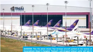  ??  ?? BANGKOK: This file photo shows Thai Airways aircraft parked on the tarmac at Suvarnabhu­mi Airport in Bangkok. Thailand’s cash-strapped national carrier will look to undergo a restructur­ing through the kingdom’s bankruptcy court, premier Prayut Chan-OCha said yesterday.—AFP