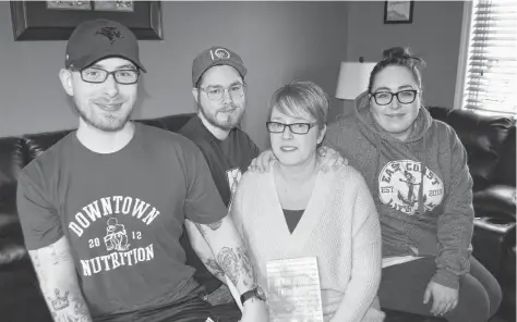  ?? SHARON MONTGOMERY-DUPE/CAPE BRETON POST ?? Shelly Breen, centre, 49, of River Ryan, holds the book ‘100 moms 1000 tips 1 Million Reasons’ by author Doreen Coady formerly of Sydney and now of Elmsdale, which she’s featured in, while gathered with three of her children, from the left, Trent, 23, Nicholas, 20, Kendall 25. Breen said the views and ideas of every parent are different and she feels Coady did an amazing job coming up with the idea and putting it all together.