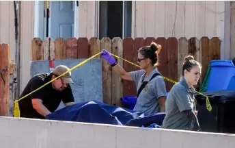  ?? IV/The San Diego Union-Tribune via AP
Hayne Palmour ?? In this 2019 file photo, a body is carried out on a gurney at the home where two adults and three children died from gunshot wounds during a domestic violence murder-suicide in the Paradise Hills area of San Diego.