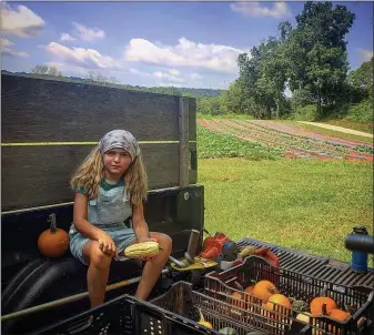  ?? PHOTO COURTESY OF STONY HILL FARM ?? John Houston’s daughter, Laila Ruth Houston, at Stony Hill Farm with some of their fall harvest offerings.