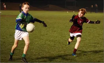  ??  ?? Jack Conneely of Glynn gets his kick away as Castletown’s Dylan Bealin looks on.