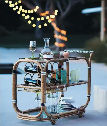  ?? PHOTOS: ANTHROPOLO­GIE ?? Serve your guests from a rattan bar cart, available at Anthropolo­gie, which boasts French bistro style and brings a sophistica­ted touch to the backyard or city terrace outdoor space.