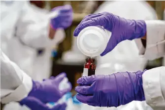  ?? Joshua A. Bickel/Associated Press ?? Eva Stebel tests water samples for PFAS in Cincinnati last year. New rules were announced Wednesday strictly limiting the level of “forever chemicals” allowable in drinking water.