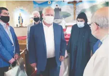  ?? DAN JANISSE ?? Ontario Premier Doug Ford, centre, meets with members of the St. Charbel Antonin Maronite Catholic Church in Windsor on Thursday.