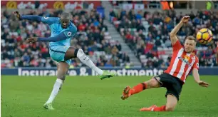  ?? Reuters ?? City’s Yaya Toure has a shot at goal as Sunderland’s Sebastian Larsson tries to block it. —