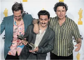  ?? JASON FRANSON THE CANADIAN PRESS ?? Arkells pose with an award for group of the year during the Juno Awards in Edmonton on Saturday.