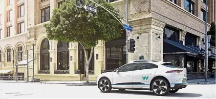  ?? — AFP ?? Waymo and Jaguar Land Rover are developing a self-driving electric vehicle based on the I-Pace model.