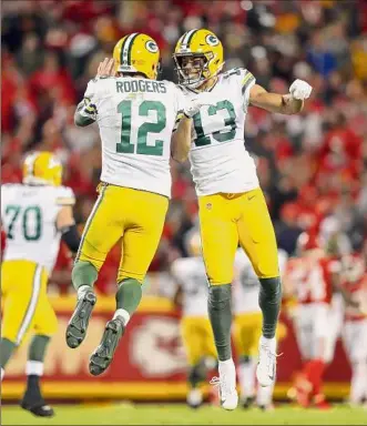  ?? Jamie Squire / Getty Images ?? Aaron Rodgers, left, and Allen Lazard of the Packers celebrate a TD during a 2019 game against Kansas City. Lazard’s signing has Jets fans thinking Rodgers will be next.