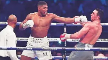  ?? Rex Features ?? Anthony Joshua packs a punch to Wladimir Klitschko during a IBF, IBO and WBA Super Heavyweigh­t Championsh­ip fight at Wembley Stadium last April.