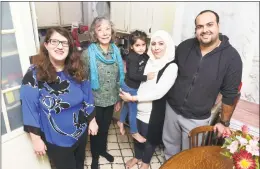  ?? Arnold Gold / Hearst Connecticu­t Media ?? Aminah, center right, with her daughter, Retaj, 4, and husband, Issa, right, in the kitchen of their New Haven home with Jean Silk, center left, coordinato­r of Jewish Community Alliance for Refugee Resettleme­nt, and Gilah Benson-Tilsen, left, JCARR team leader for Congregati­on Beth El-Keser Israel.