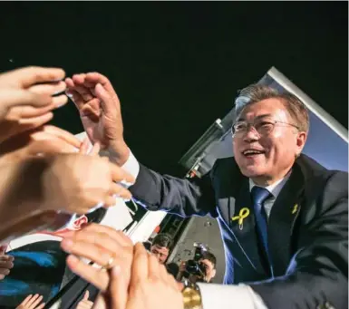  ?? CHUNG SUNG-JUN/GETTY IMAGES ?? South Korean president-elect Moon Jae-in greeted supporters after his victory was confirmed on Tuesday in Seoul, South Korea.