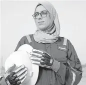  ?? NABIL AL-JOURANI/AP ?? Zainab Amjad stands near an oil field outside Basra. She has bypassed the typical office jobs often given to female petrochemi­cal engineers in Iraq.