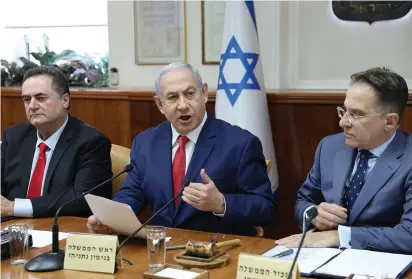  ?? (Abir Sultan/Pool/Reuters) ?? PRIME MINISTER Benjamin Netanyahu addresses the weekly cabinet meeting in Jerusalem on Sunday, as Foreign Minister Israel Katz and Government Secretary Tzachi Braverman look on.