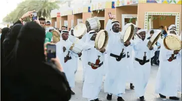  ?? — Reuters ?? Loyal citizens: Saudi people wearing traditiona­l clothes perform during the 89th annual National Day of Saudi Arabia in Riyadh recently. Many Saudis see the IPO as a demonstrat­ion of loyalty as tension mounts in the Gulf.