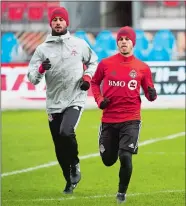  ?? NATHAN DENETTE/THE CANADIAN PRESS VIA AP ?? Toronto FC midfielder Victor Vazquez, left, and forward Sebastian Giovinco warm up during practice Friday on the eve of today’s MLS Cup final against Seattle.