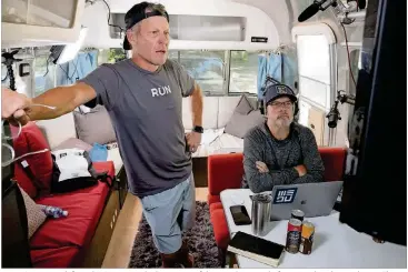  ?? PHOTOS CONTRIBUTE­D BY DAVE BOLCH ?? Lance Armstrong, left, and JB Hager watch a livestream of the Tour de France before recording their podcast, “The Move,” in an Airstream trailer in Aspen, Colo.