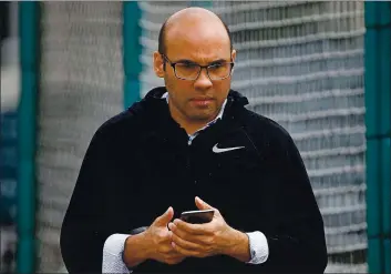  ?? KARL MONDON — BAY AREA NEWS GROUP, FILE ?? Farhan Zaidi, the Giants’ president of baseball operations, texts on his phone after watching pitchers and catchers work out at Scottsdale Stadium in February 2019.