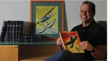  ??  ?? Air Age, Inc., CEO Louis DeFrancesc­o, grandson of founder George Campbell Johnson, holds the December 1957 issue of Model Airplane News. The artwork by legendary illustrato­r Jo Kotula was used to re-create the cover for our January 2019 issue.