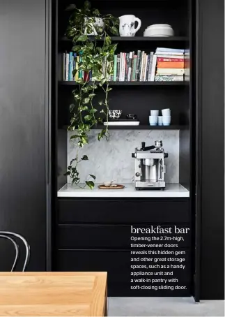  ??  ?? breakfast bar
Opening the 2.7m-high, timber-veneer doors reveals this hidden gem and other great storage spaces, such as a handy appliance unit and a walk-in pantry with soft-closing sliding door.