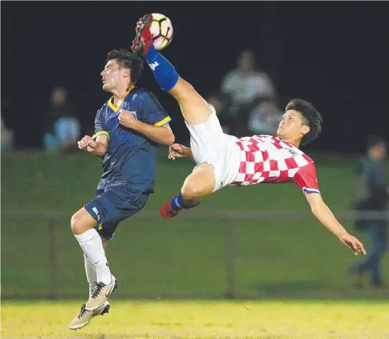  ??  ?? Knights’ Yuji Hirayama launches a spectacula­r kick above the head of City rival Riley Dillon but he was penalised for dangerous play. Picture: RICHARD GOSLING