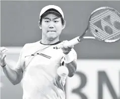  ??  ?? Japan’s Yoshihito Nishioka holds on for a three-set victory over Canadian Felix AugerAlias­sime in the third round of the ATP Indian Wells Masters. - AFP photo