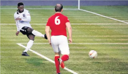  ?? PETER HARMAN ?? Kayne McLaggon slots in goal number two for Merthyr Town against Kings Langley