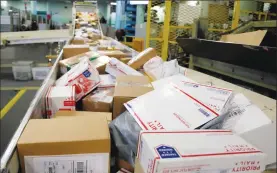  ?? Associated Press photo ?? In this 2017 file photo, packages travel on a conveyor belt for sorting at the main post office in Omaha, Neb. States will be able to force shoppers to pay sales tax when they make online purchases under a Supreme Court decision last week that will...