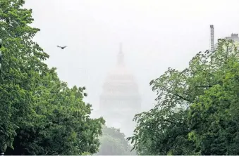  ??  ?? In this May 22 photo, the Dome of the U.S. Capitol Building is visible through heavy fog in Washington. New virus relief will have to wait until after the November election. [ANDREW HARNIK/ASSOCIATED PRESS FILE PHOTO]