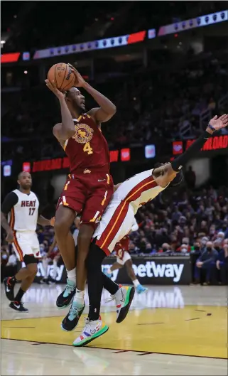  ?? TIM PHILLIS — FOR THE NEWS-HERALD ?? Rookie Evan Mobley, shown against the Heat on Dec. 13, is one of the biggest contributo­rs to the Cavaliers’ resurgence this season