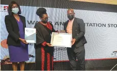  ?? ?? Zimbabwe Parks and Wildlife Management Authority’s Internatio­nal Conservati­on Affairs Director Professor Patience Gandiwa (centre) hands over the award to Sunday Mail`s Leroy Dzenga as Rainbow Tourism Group Corporate Affairs and Quality Manager Pride Khumbula looks on