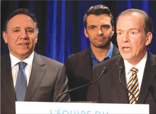  ?? GORDON LAMBIE ?? CAQ party leader Francois Legault and Drummond-bois-francs MNA Sébastien Schneeberg­er with Richmond candidate André Bachand in Sherbrooke on Monday