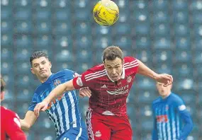  ??  ?? Aberdeen’s Andy Considine clears the ball from Jordan Jones.