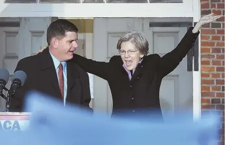  ?? STAFF PHOTOS BY NANCY LANE ?? IN HAND: Mayor Martin J. Walsh and Sen. Elizabeth Warren, above, lead yesterday’s rally at Faneuil Hall to save Obamacare. The rally, right, drew thousands.