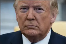  ?? EVAN VUCCI — THE ASSOCIATED PRESS ?? President Donald Trump listens during a meeting in the Oval Office of the White House in Washington on Jan. 27.