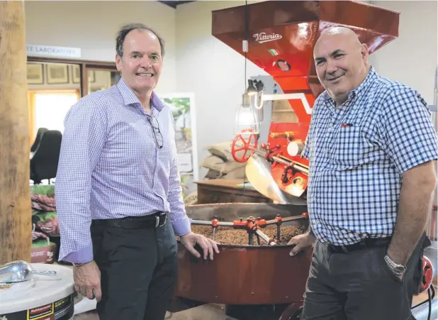  ?? Picture: BRONWYN WHEATCROFT ?? GOOD VALUE: Rob Olver of Aus Industry Entreprene­urs and Mareeba chamber president Joe Moro at Skybury Coffee.