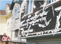  ?? DARREN MAKOWICHUK FILES ?? Homeowner Dave Reichert looks over the damage to his house after a hailstorm on June 13.