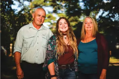  ?? STAFF PHOTO BY TROY STOLT ?? Autumn Cordell poses for a portrait with her parents, Jeffery and Mitzi Frederick Cordell, on Monday in McDonald, Tenn. Autumn Cordell was born Sept. 11, 2001, as the first hijacked plane struck the World Trade Center in New York City. On the same day the lives of almost 3,000 Americans were claimed in the attacks, the Cordells celebrated the arrival of a new life, their daughter.